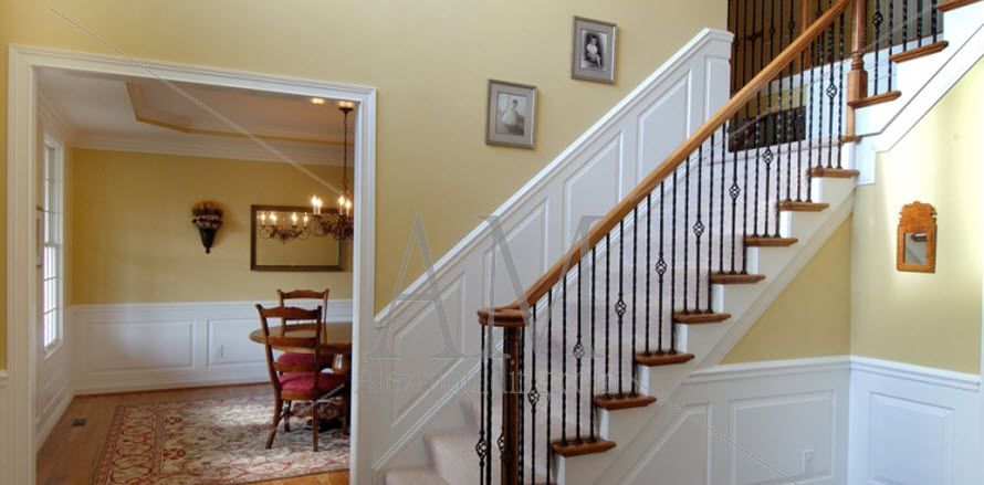 round curved staircase with raised panel wainscoting